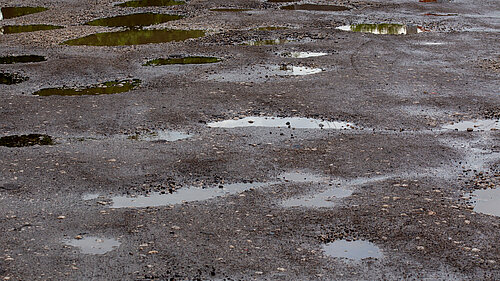 A road filled with potholes.