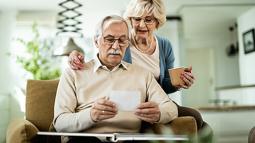 Mature couple looking at their photo album.