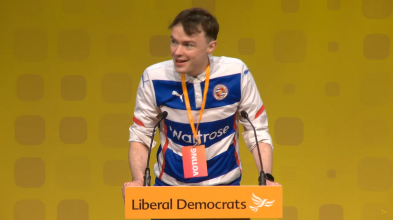 Henry Wright, Lib Dem Candidate for Reading Central, addresses the Lib Dem Conference wearing a Reading FC strip