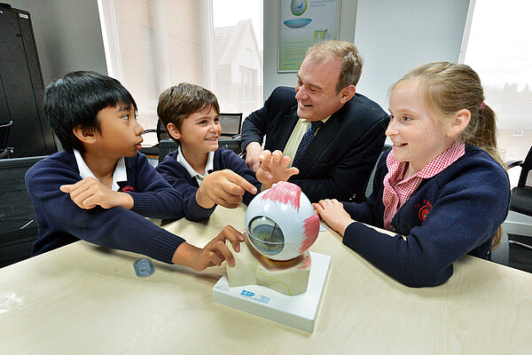 Party leader Sir Ed Davey with some school children